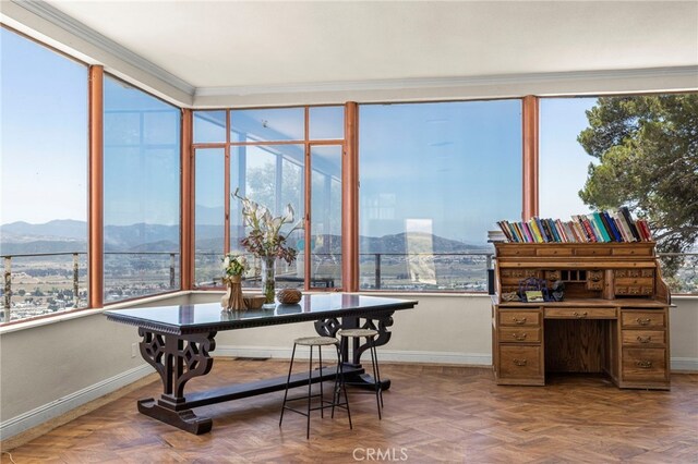 sunroom with a mountain view and a healthy amount of sunlight