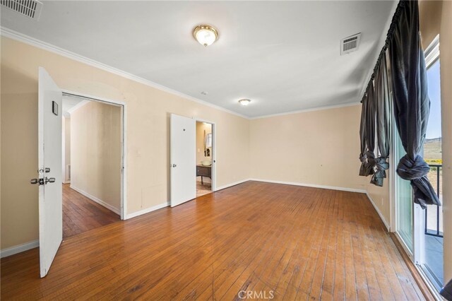 unfurnished room featuring hardwood / wood-style flooring and ornamental molding