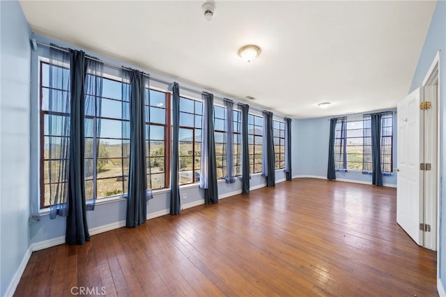 unfurnished room featuring dark wood-type flooring