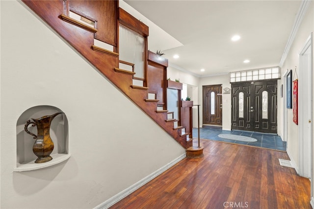 foyer featuring dark hardwood / wood-style flooring and crown molding