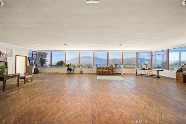 interior space with a mountain view and a textured ceiling