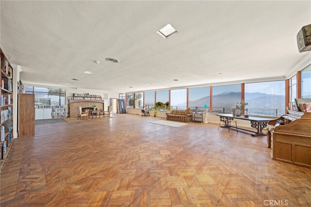 miscellaneous room with a mountain view and a textured ceiling