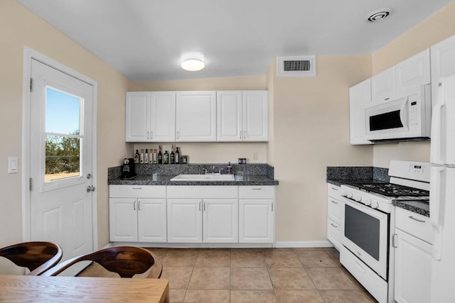 kitchen featuring white cabinets, white appliances, and sink