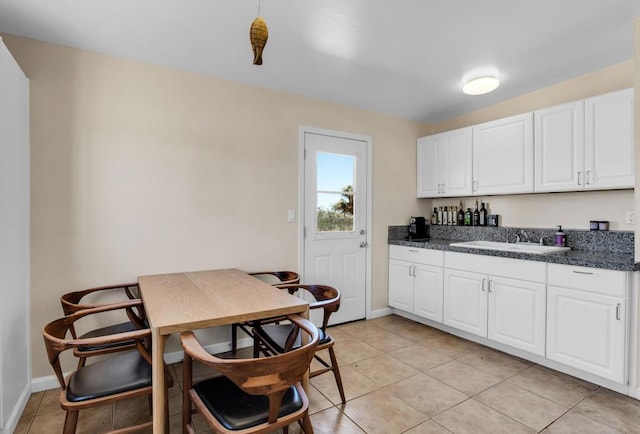 kitchen featuring sink, white cabinets, and light tile patterned floors