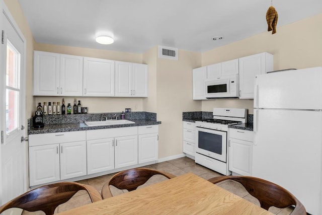 kitchen featuring white cabinets, white appliances, sink, and light tile patterned floors