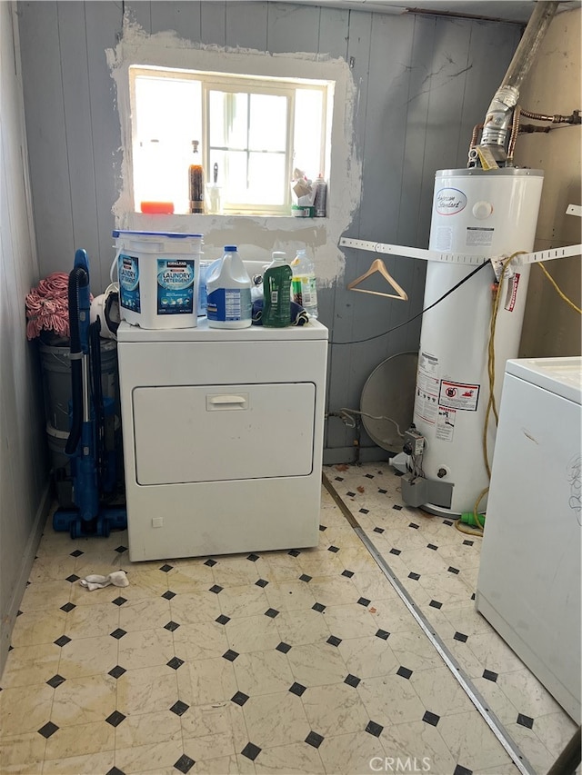 clothes washing area featuring separate washer and dryer and gas water heater