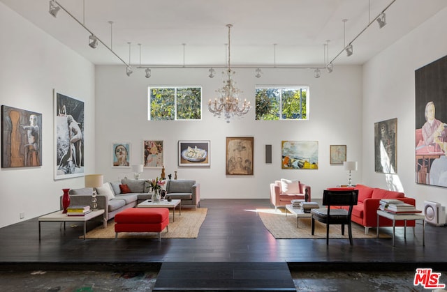 living room with rail lighting, dark hardwood / wood-style flooring, and plenty of natural light