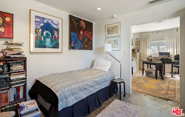 bedroom featuring concrete flooring