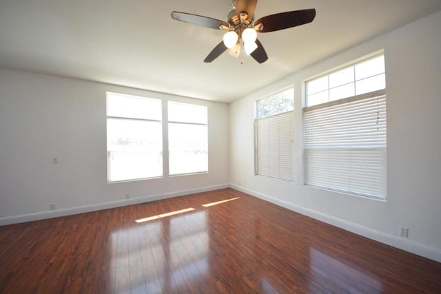 unfurnished room featuring plenty of natural light, dark hardwood / wood-style floors, and ceiling fan