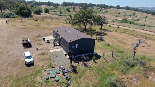 birds eye view of property with a rural view