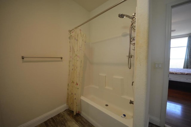 bathroom featuring hardwood / wood-style flooring and shower / tub combo