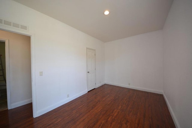 spare room featuring dark hardwood / wood-style floors