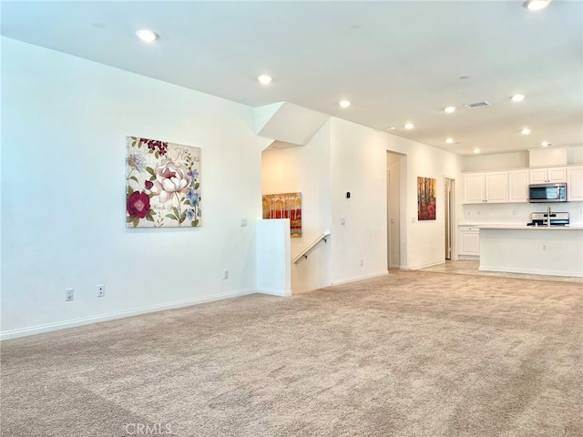 unfurnished living room with light carpet