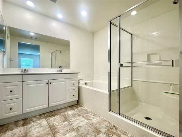 bathroom featuring vanity and plus walk in shower