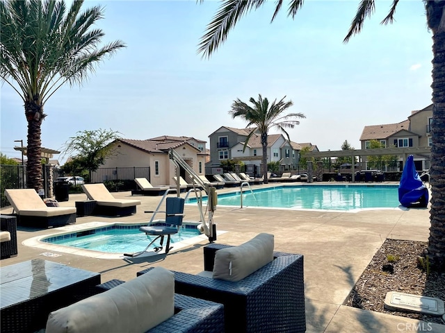 view of pool with a patio area and a hot tub