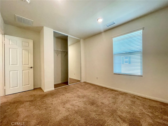 unfurnished bedroom featuring a closet and carpet floors