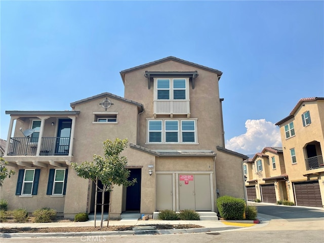 view of front of house with a balcony and a garage