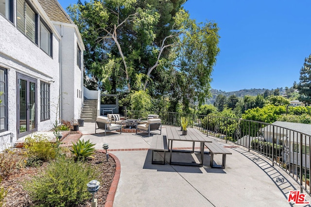 view of patio featuring an outdoor living space with a fire pit