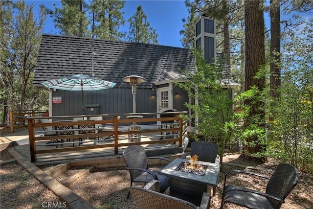 view of patio with a fire pit and a wooden deck