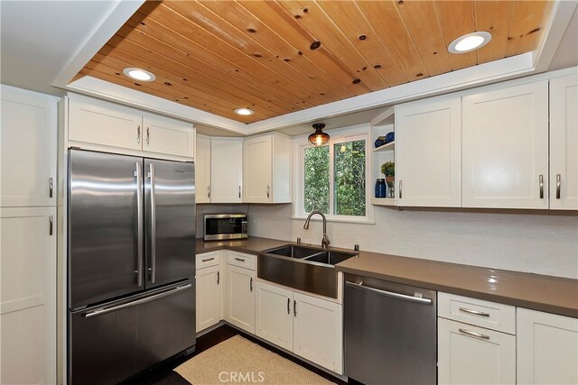 kitchen featuring stainless steel appliances, sink, and white cabinets