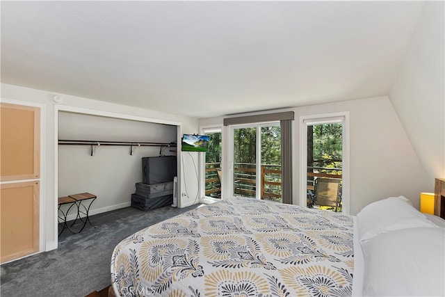 bedroom with a closet, access to outside, vaulted ceiling, and dark carpet