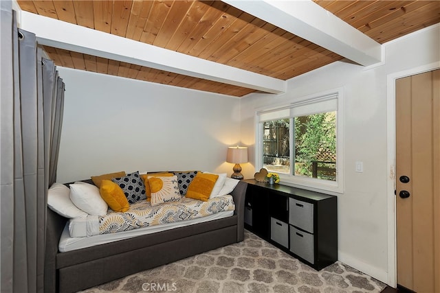 living area featuring beam ceiling, light carpet, and wood ceiling