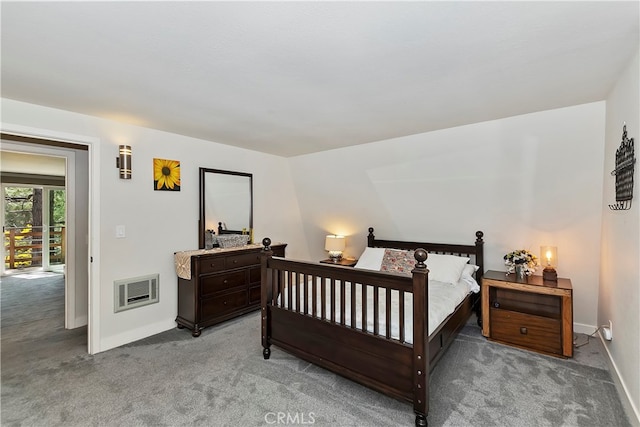 bedroom featuring lofted ceiling, light carpet, and heating unit