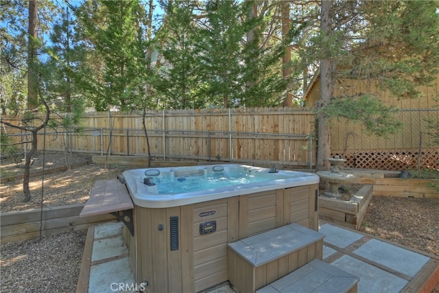 view of swimming pool with a hot tub