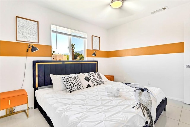 bedroom with light tile patterned floors, baseboards, and visible vents