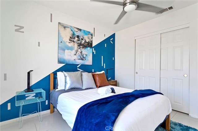 bedroom featuring a ceiling fan, tile patterned flooring, visible vents, and a closet