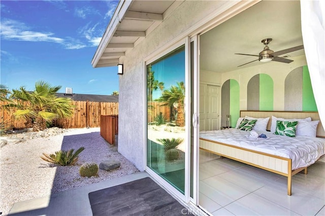 exterior space featuring ceiling fan and fence