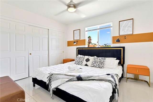 bedroom featuring a ceiling fan, a closet, and light tile patterned flooring