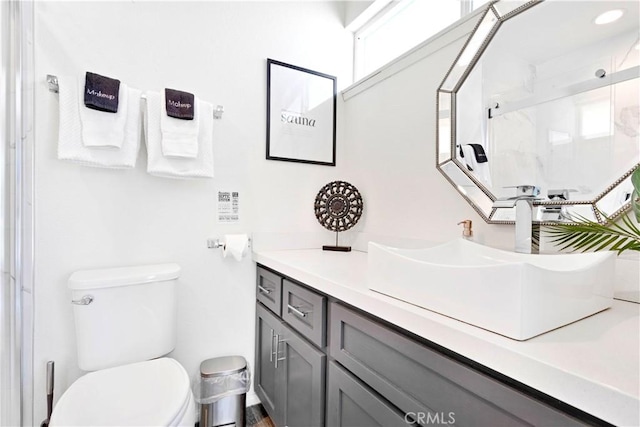 full bath featuring a shower stall, toilet, and vanity