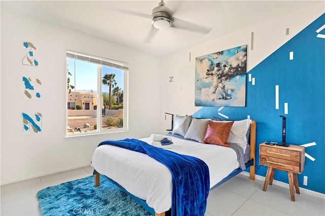 bedroom featuring baseboards, a ceiling fan, and tile patterned floors