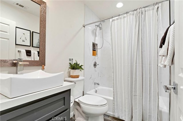 bathroom with toilet, shower / bath combo with shower curtain, vanity, and visible vents