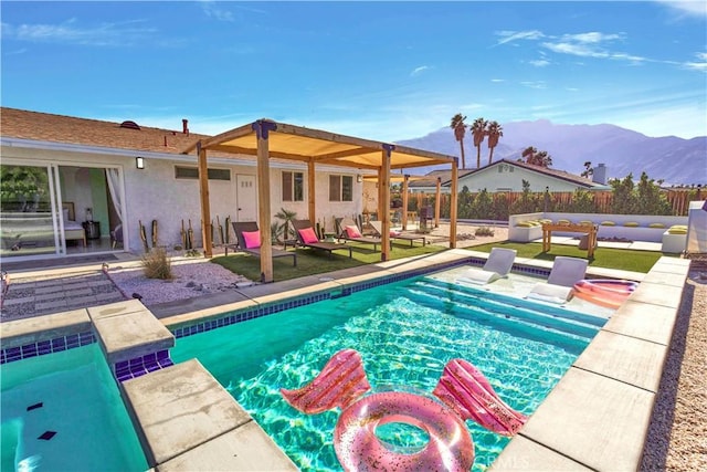 view of pool featuring a patio area, fence, a mountain view, and a fenced in pool