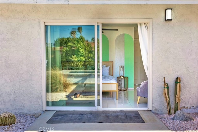 property entrance with stucco siding