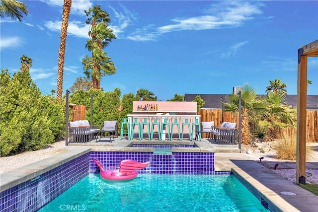 view of swimming pool featuring a fenced in pool, a patio area, fence, and an outdoor hangout area