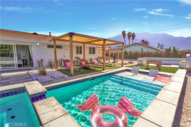 view of pool with a patio, a jacuzzi, and a mountain view