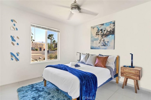 bedroom with baseboards, a ceiling fan, and light tile patterned flooring