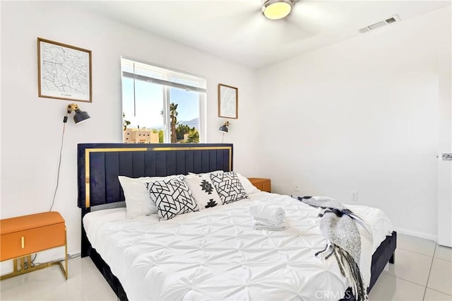 bedroom featuring light tile patterned floors, baseboards, and visible vents