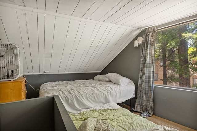 bedroom featuring vaulted ceiling and wood ceiling