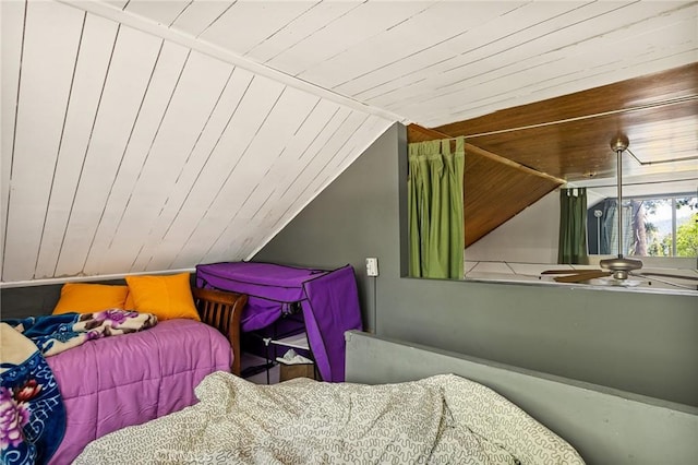 bedroom with wooden walls, wood ceiling, and vaulted ceiling