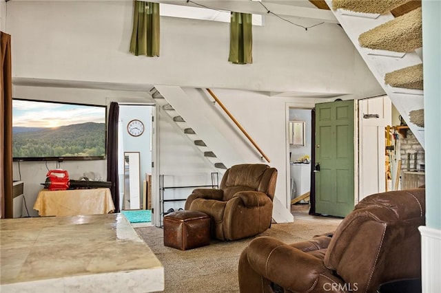 carpeted living room with high vaulted ceiling