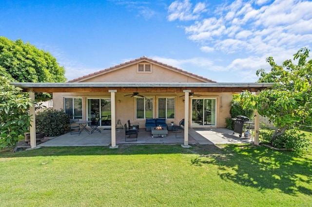 back of house featuring a patio, a lawn, and ceiling fan