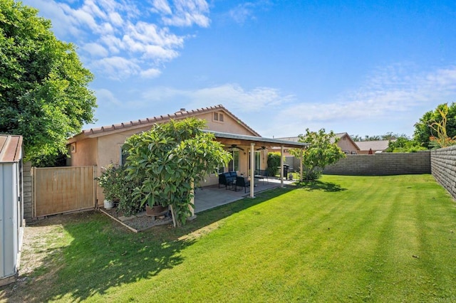 rear view of house featuring a patio and a lawn