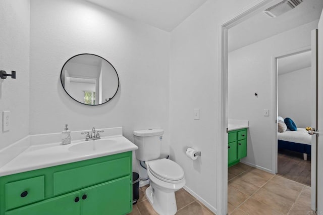 bathroom with vanity, toilet, and tile patterned floors