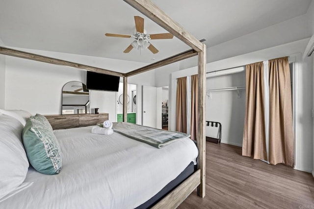 bedroom with a closet, ceiling fan, vaulted ceiling, and hardwood / wood-style floors