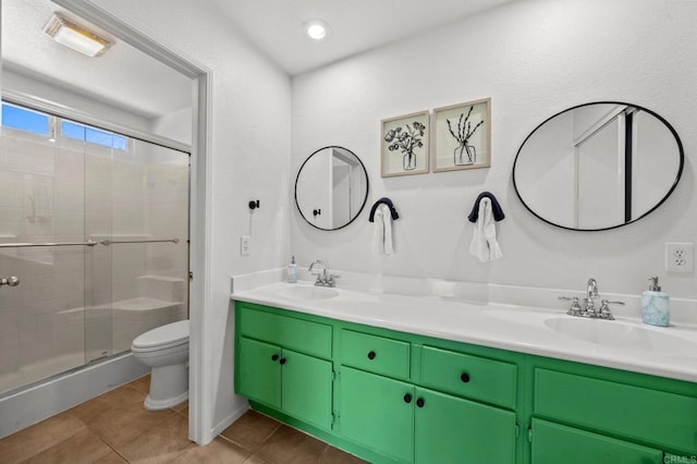 bathroom with vanity, a shower with shower door, toilet, and tile patterned floors