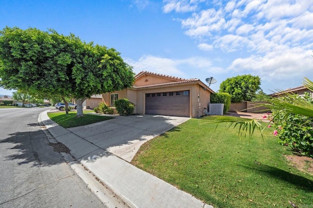 view of front of property with a front yard and a garage